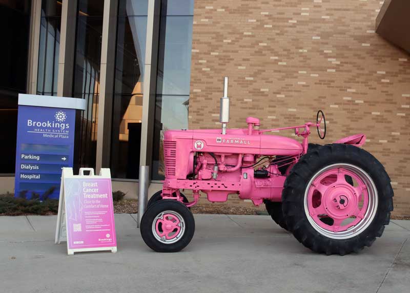 A pink,1952 Farmall Super M is parked in front of Brookings Health System for the next week to help make the community aware that breast conserving surgery is now available at Brookings Hospital. Using the newly acquired SAVI SCOUT surgical guidance system, Dr. Sara Marroquin and Brookings Health’s surgical team will perform breast conserving procedures to help save the breasts of local patients with early-stage breast cancer. Community members who take a photo of the tractor and share it on social media will have a chance to win one of two pink toy tractor and trailer sets. 