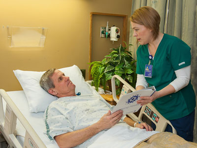 Medical-Surgical Nurse Elizabeth Kuhl, RN, explains contents of the MyHealth Matters binder to a hospital patient. The binder is used for patient discharge planning, one of the areas examined by the South Dakota Department of Health’s new Patient Safety Initiative survey. For the second consecutive year, the department of health cited no deficiencies to Brookings Health System’s hospital during its most recent health survey. 
