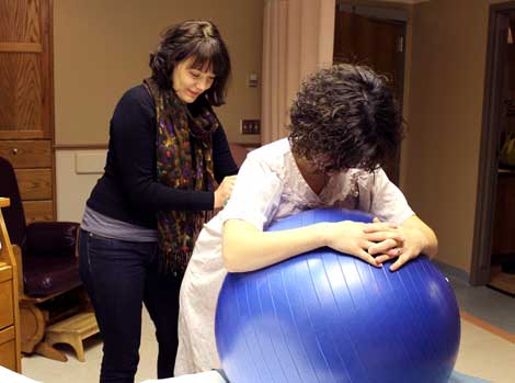 Taylor Mertz, a volunteer doula at Brookings Health System, demonstrates labor relaxation techniques to expectant mother Katy VanderWal.