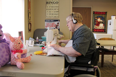 Darlene Carpenter, resident at The Neighborhoods at Brookview, listens to her personal playlist of 50s and 60s music as she works on her sewing. The Neighborhoods is now one of 55 nursing homes in South Dakota to become Music & Memory® Certified, a therapeutic program that brings residents pleasure, improves mood and reduces anxiety. The program has also been proven to help improve dementia.