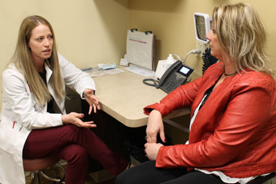 Gynecologist Dr. Larissa Bennis talks with a patient about endometrial ablation in the office