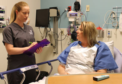 Gynecologist Dr. Larissa Bennis talks to a patient prior to a procedure in same-day surgery