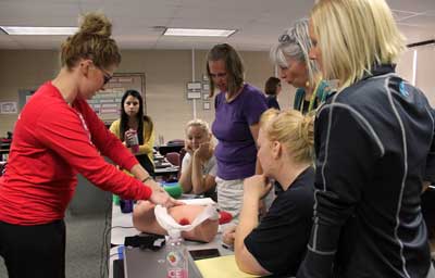 Trauma Educator Chelsey Sundberg, RN, demonstrates how to pack a wound for Deubrook Elementary staff. Brookings Health is offering free the “Stop the Bleed” education to all Brookings County schools this fall. The program empowers bystanders to intervene in a bleeding emergency and save lives. Pictured above (from left) are Sundberg, Alyssa Campbell, Karley Olsen, Carla Ramlo, Tammy Jo Schlechter, Melissa Holmlund and Megan Hawks.