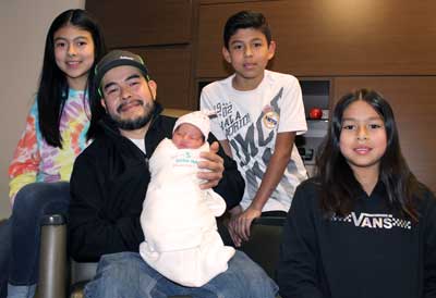 Alejandra Navid Garcia Martinez was born at 12:54 a.m. on New Year’s Day, making her the first baby of the New Year at Brookings Health System. Holding Alejandra is her father, Luis. Also pictured with her are her older siblings, Maria Guadalupe, Luis Eduardo and Maria Isabel.