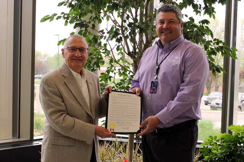Brookings Mayor Keith Corbett presents CEO Jason Merkley with the proclamation that recognizes May 18 – 25 as Brookings Health System Week in the City of Brookings. The proclamation mentions the health system’s recent quality achievements, including being named a 2020 Top 20 Rural Community Hospital. Prior to the COVID-19 pandemic, Brookings Health would have been recognized this week as a Top 20 hospital at the National Rural Health Association’s annual summit. 