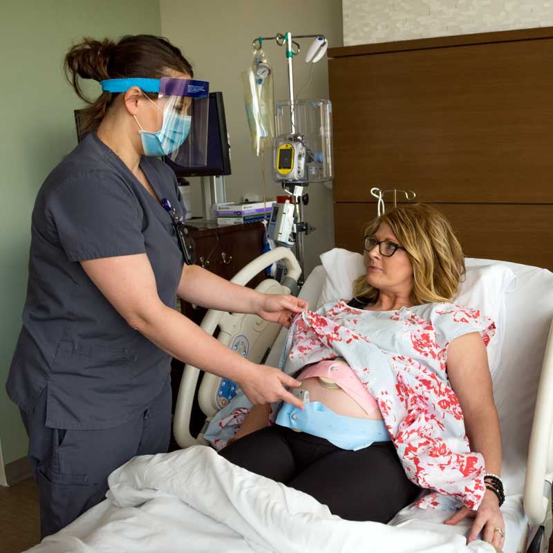 Obstetrics Nurse Lacy Maher, RN, checks the position of the fetal monitoring belts on expectant mother Chelsey Sundberg. Brookings Health recently implemented new fetal monitoring software that uses artificial intelligence to help healthcare providers identify early warning signs during childbirth, increasing the safety for both mother and baby.