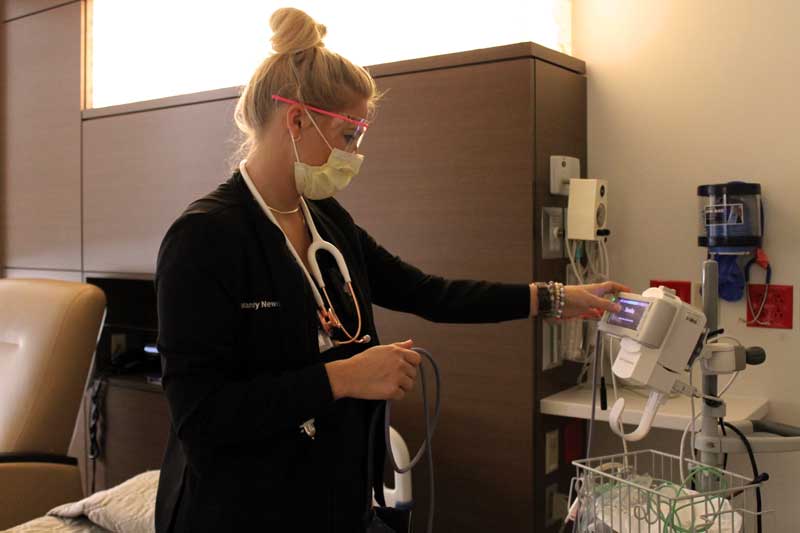 OR Registered Nurse Mandy Newman prepares a patient room while floating to the inpatient care unit at Brookings Hospital. Sufficient clinical staffing to handle the added patient load created by the COVID-19 pandemic is an ongoing concern for Brookings Health System. One of the measures the health system is taking to handle the pandemic is reassigning clinical staff, like Mandy, to areas where there is the most need. In addition, the health system has started an on-call sign-up, requiring staff to be available if needed for two extra shifts per week.