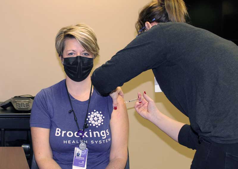 McKenzie Nielsen, RN, receives the first COVID-19 vaccine dose administered by Brookings Health System. Today Brookings Health started vaccinating local medical personnel caring for COVID-19 patients following the South Dakota Department of Health’s COVID-19 Vaccination Plan. Brookings Health will continue vaccinations following the Department of Health’s plan as more doses become available.