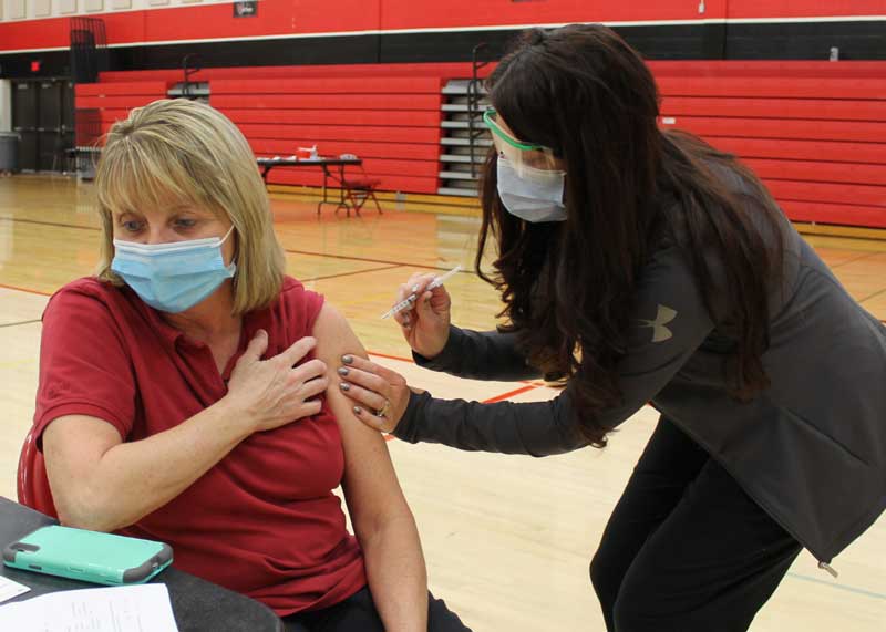 Brookings Health System Nurse Jodi Tolzin, RN, administers a COVID-19 vaccine dose to Dawn Pickard who works in child nutrition at Medary Elementary. Teachers and other school/college staff fall under phase 1d in the South Dakota Department of Health’s vaccination plan and are part of the current group that Brookings Health System and its partners are working on vaccinating. Currently 20 percent of Brookings County’s population has received a vaccine. To reach herd immunity 70 to 90 percent of the population must be vaccinated.