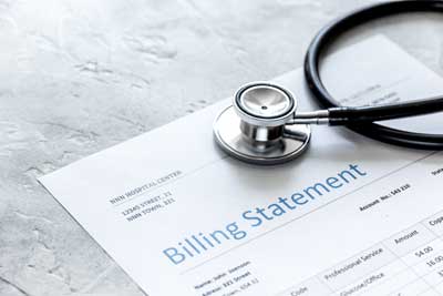 photo of medical bill lying on a counter with a stethoscope on top of it