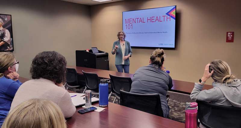 NAMI South Dakota presenter Angela Hyde educates Brookings Health System employees about mental health and how to reduce the stigma of mental health conditions at a recent training session. Brookings Health provided education to employees as a part of becoming a NAMI StigmaFree partner. The health system took NAMI’s StigmaFree Workplace pledge in an effort to support the mental health and wellbeing of team members. 