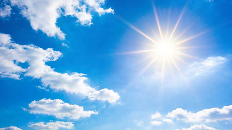 photo of the sun, shining brightly and hotly in a blue sky