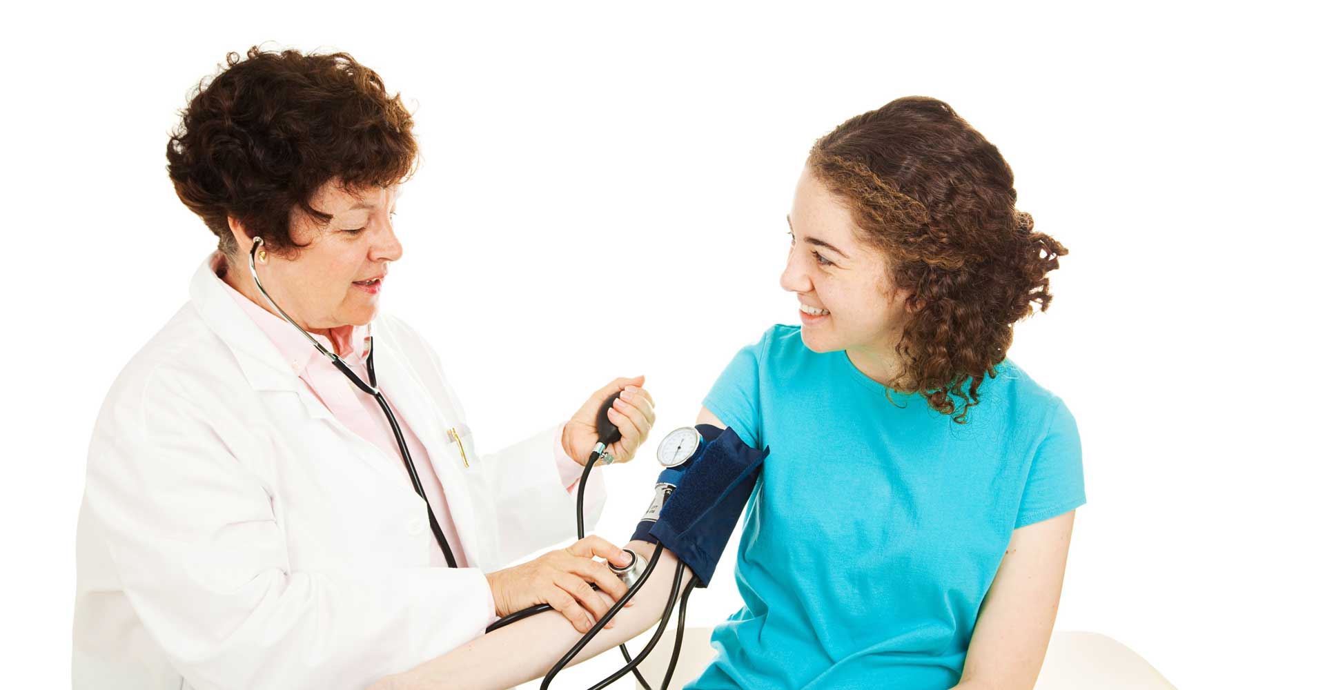 female medical provider taking the blood pressure of a female teenager