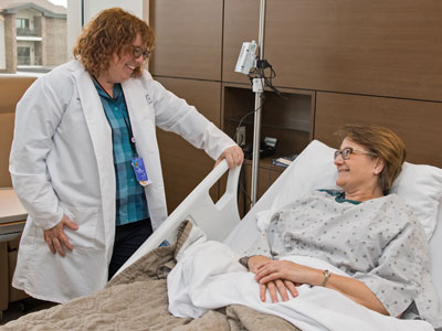 Doctor meeting with patient in hospital room