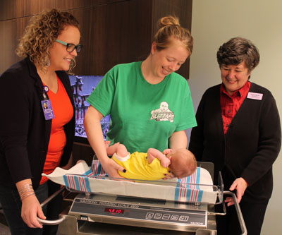Mother LeAnn Hansen-Conn places her three-week old baby boy, Jackson, on a scale at New Beginnings Baby Café to weigh him with the assistance of IBCLC Lactation Consultants Aleycia Gerlach, left, and Charlotte Bachman, right. Brookings Health System recently expanded Baby Café hours to Thursday afternoons in order to better support mothers and help them successfully breastfeed their infants.