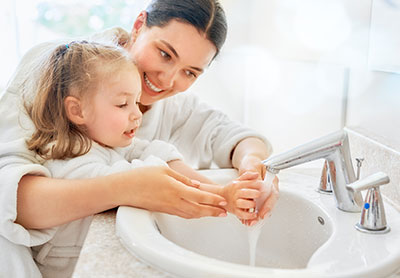 Woman and child washing hands image