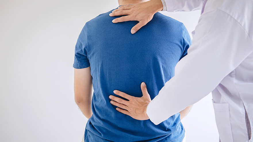 Man with back pain seeing Provider