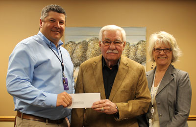 Brookings Health System CEO Jason Merkley (left) and Foundation Development Officer Barb Anderson (right) present a $5,000 check to Don Boone (center) of the Volunteer Service Bank. The organization matches volunteers with people and projects needing help within Brookings County.