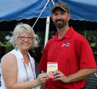 Rod Brandenburger earned the top adult individual score at the Aiming to Inspire Health fundraiser. Foundation Development Officier Barb Anderson presents him with his prize.