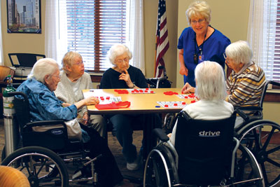 Increased socialization and stronger relationships between residents and staff are some of the improvements being seen at The Neighborhoods at Brookview. Here residents gather with volunteers and staff to play bingo, a popular activity at The Neighborhoods. Pictured from left to right are Hannah Jensen, Volunteer Marian Borstad, Marian Heidemann, Household Coordinator Barb Landsman, Maxine Nichols and Dorothy Connolly. 