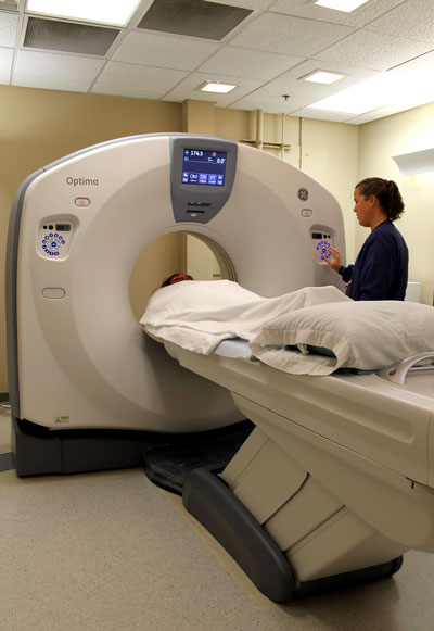 Radiology Technologist Julie Nylund positions a patient in the new CT scanner. The new CT system quickly takes high resolution, digital images of patient anatomy at a 40 percent reduced radiation dose to help care providers better diagnose and treat patients.