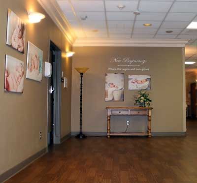 The newly remodeled entrance at New Beginnings Birth Center displays the refurbished floors and wall coverings throughout the OB unit as well as wall art of babies provided by local photographers. The new décor helps to create a relaxing atmosphere for parents-to-be.