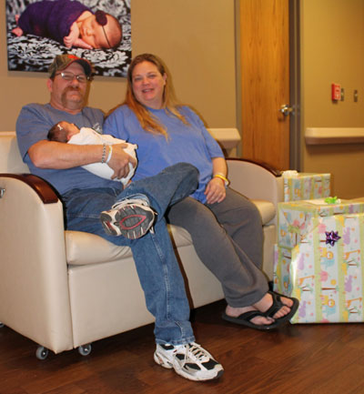 Mike Hein and Dustine Knutson hold their new little girl, Courtney, who was the first baby of the New Year born at Brookings Health System. As the first baby, Courtney and her parents received a variety of gifts from local businesses and organizations. 