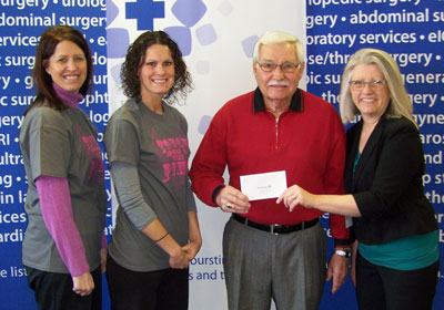 Jenny Hammrich, Swiftel Center director of sales and marketing, Molly Eich, Swiftel Center box office manager, and Barb Anderson, Brookings Health System Foundation development officer, present a $5,000 check to Don Boone, Volunteer Service Bank coordinator. 