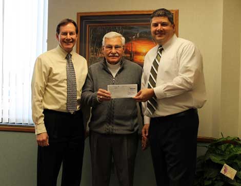 Brookings Health System Board of Trustees Chair Al Baker (left) and CEO and President Jason Merkley (right) present a $5000 check to Don Boone of the Volunteer Service Bank.