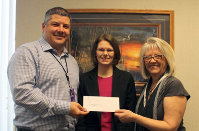 Brookings Health System CEO Jason Merkley (left) and Foundation Director Barb Anderson (right) present a $5,000 check to Kyleigh Cramer (center), program director of the Volunteer Service Bank. The organization matches volunteers with people and projects needing help within Brookings County.