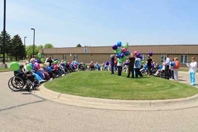Brookview Manor residents and staff prepare to release 79 balloons to kick off groundbreaking celebrations. Each balloon is attached with a tag, asking people who find the balloon to contact Brookview Manor to tell them where the balloon landed.