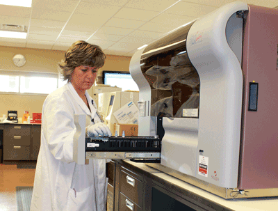 Laboratory technologist Mindy Johnson inserts patient samples into the new coagulation analyzer at Brookings Health System.