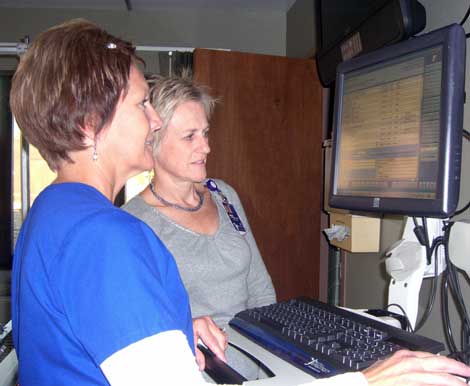 Clinical Application Leaders Bev Cotton, RN, and Lynne Thompson, RN, review EHR information in one of the patient rooms at Brookings Health System.