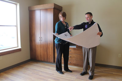 Hospice and Home Health Director Lynne Kaufmann and Brookview Administrator Jason Hanssen look over architectural plans in the first hospice suite at The Neighborhoods at Brookview that will have enhanced amenities thanks to donations made to the Brookings Health System Foundation.