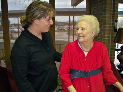 Certified Occupational Therapy Assistant Laura Crooks assists Dorothy Schaller with occupational therapy rehabilitation.