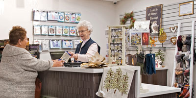 Volunteer at cash register assisting a customer